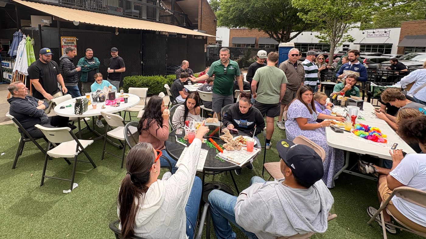 Rebels players and families sharing the post-match meal together at long tables